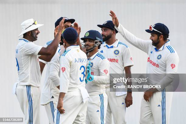 Ravichandran Ashwin , Mohammed Siraj , Ishan Kishan and Rohit Sharma of India celebrate the dismissal of Tagenarine Chanderpaul of West Indies during...