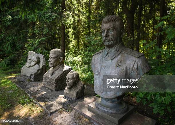 Busts of Joseph Stalin, Vladimir Lenin and other communist leaders seen inside Grutas Park, a captivating museum featuring Soviet-era statues, and...