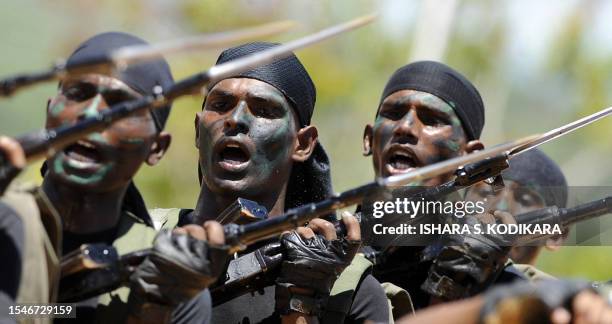 Sri Lankan Air Force troops display their commando skills during a passing out ceremony of 329 men and officers in the north-eastern town of...