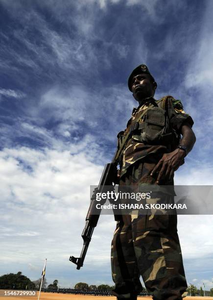 Sri Lankan soldier stands guard as airforce troops parade at the passing out ceremony of 329 men and officers in the north-eastern town of...