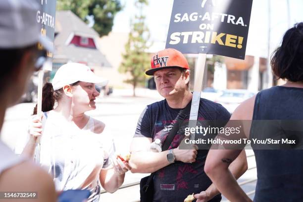 Adam Hicks walks the picket line in support of the SAG-AFTRA and WGA strike on July 21, 2023 in Los Angeles, California.