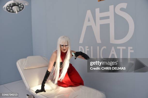 An actress holds a syringe at a "American Horror Story: Delicate" booth at the FX immersive presentation during San Diego Comic-Con International in...