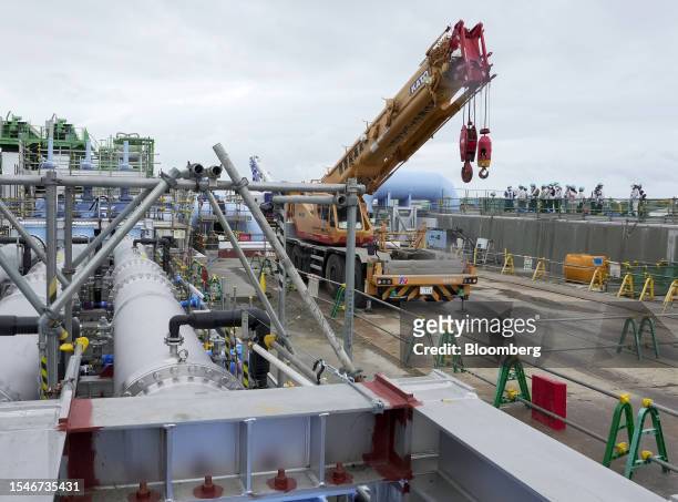 Members of the media look at the advanced liquid processing system , used for treating accumulated contaminated water, during a media tour at Tokyo...