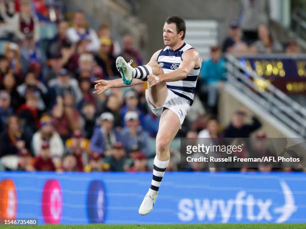 Patrick Dangerfield of the Cats kicks a goal during the 2023 AFL Round 19 match between the Brisbane Lions and the Geelong Cats at The Gabba on July...