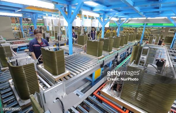 Workers make home air conditioners at a New Energy company production workshop in Anqing City, Anhui Province, China, July 21, 2023.