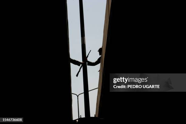 Thai soldiers help each other to take position on a flyover during an operation to take control of an area around the fortified ''Red shirt''...