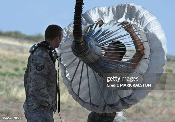 United States Air Force crew prepare an aerial refueling rig on a C-130 plane before a rescue operation during Exercise Angel Thunder, near the town...