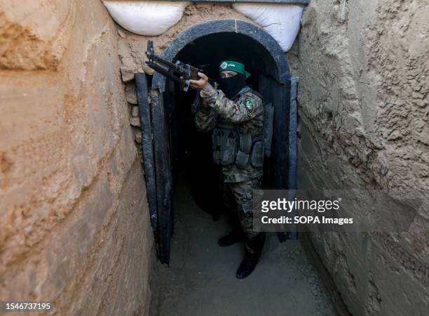 Fighter from Izz al-Din al-Qassam stands in front of a tunnel during an exhibition of weapons, missiles and heavy equipment for the military wing of...