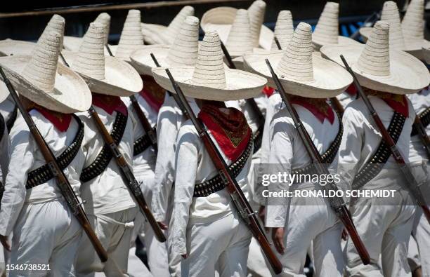 Soldiers of the Mexican Army dressed as revolutionaries, parade during the celebrations of the 200th anniversary of the country's independence at the...