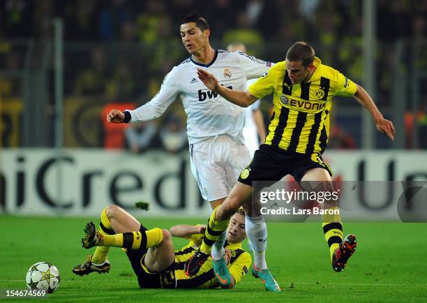 Cristiano Ronaldo of Madrid is challenged by Marco Reus and Sven Bender of Dortmund during the UEFA Champions League group D match between Borussia...