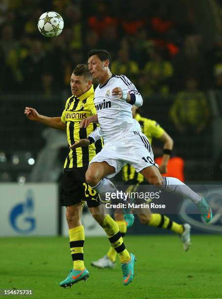 Lukasz Piszczek of Dortmund and Mesut Oezil of Madird head for the ball during the UEFA Champions League group D match between Borussia Dortmund and...