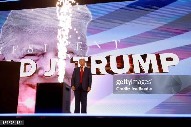 Former US President Donald Trump arrives on stage at the Turning Point Action conference as he continues his 2024 presidential campaign on July 15,...