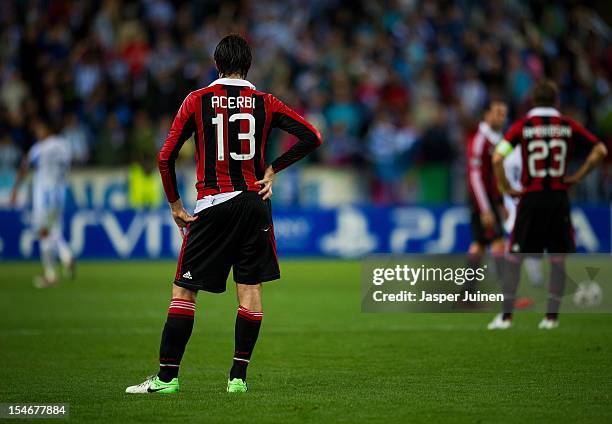 Francesco Acerbi of AC Milan stands dejected after conceding a goal during the UEFA Champions League group C match between Malaga CF and AC Milan at...