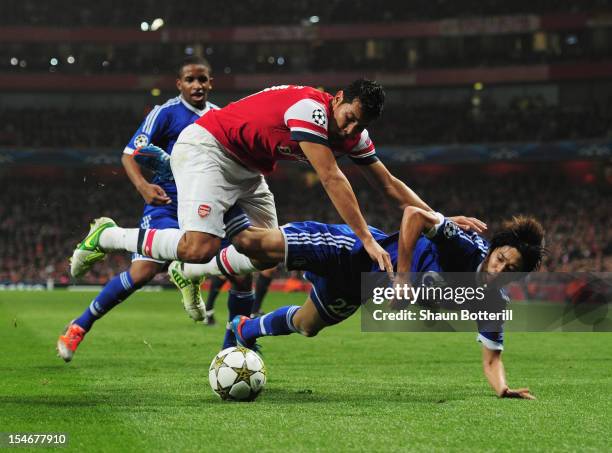 Andre Santos of Arsenal challenges Atsuto Uchida of Schalke 04 during the UEFA Champions League Group B match between Arsenal and FC Schalke at the...