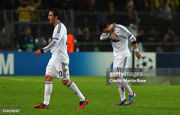 Mesut Oezil of Madird and team mate Gonzalo Higuain look dejected after the UEFA Champions League group D match between Borussia Dortmund and Real...