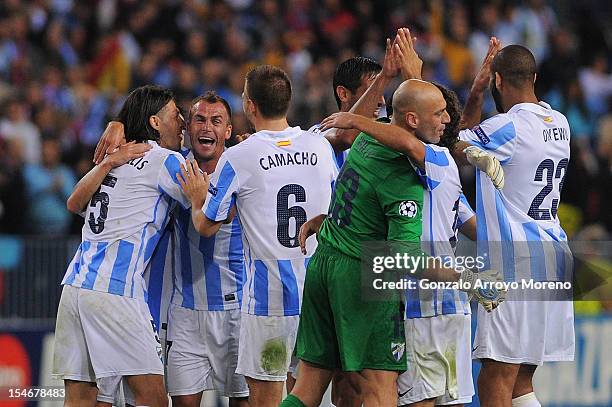 Martin G. Demichelis of Malaga CF celebrates victory with teammates Joaquin Sanchez , Ignacio Camacho , goalkeeper Willy Caballero and Oguchi Onyewu...