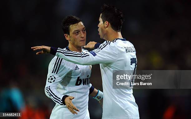 Cristiano Ronaldo of Madrid celebrates with team mate Mesut Oezil after scoring his teams first goal during the UEFA Champions League group D match...