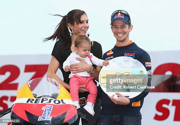 Casey Stoner of Australia and the Repsol Honda Team poses with his wife Adriana and baby daughter Alessandra Maria, after turn three of the Phillip...