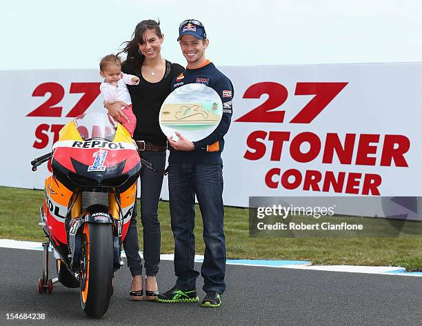 Casey Stoner of Australia and the Repsol Honda Team poses with his wife Adriana and baby daughter Alessandra Maria, after turn three of the Phillip...