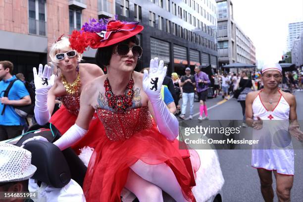 Participant with a red dress waves during the annual Christopher Street Day parade on July 22, 2023 in Berlin, Germany. CSD Berlin is among Europe's...