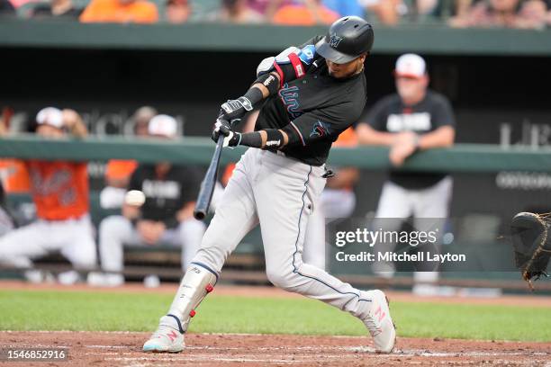 Luis Arraez of the Miami Marlins singles in a run in the first inning in the first inning during a baseball game against the Baltimore Orioles at...