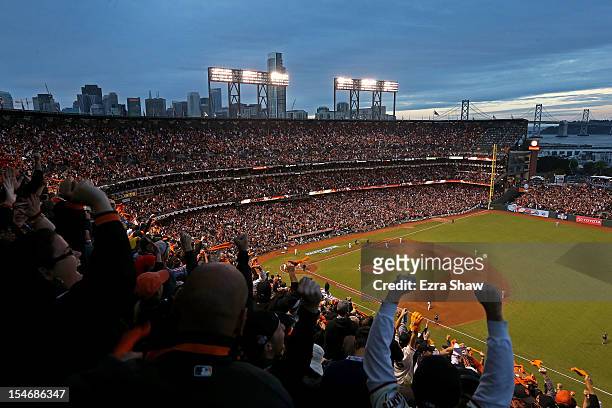 Fans cheer as Pablo Sandoval of the San Francisco Giants rounds the bases after scoring a two run home run to left field against Justin Verlander of...