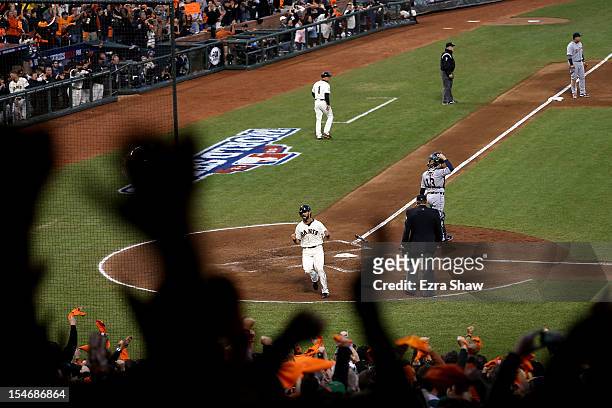 Angel Pagan of the San Francisco Giants celebrates after scoring a run hit by Marco Scutaro of the San Francisco Giants against Justin Verlander of...