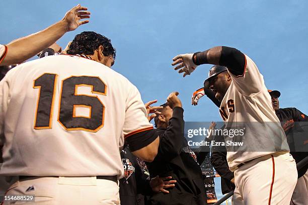 Pablo Sandoval of the San Francisco Giants celebrates with teammate Angel Pagan after scoring a two run home run to left field against Justin...