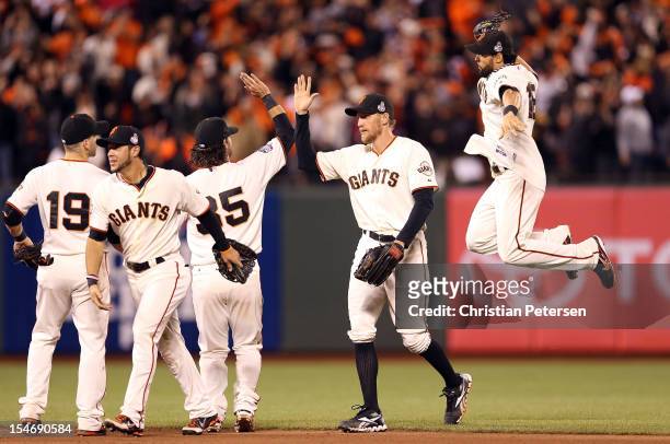 Angel Pagan of the San Francisco Giants an celebrates with his teammates after defeating the Detroit Tigers in Game One of the Major League Baseball...