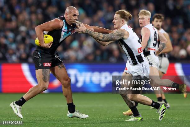 Sam Powell-Pepper of the Power and Beau McCreery of the Magpies during the 2023 AFL Round 19 match between the Port Adelaide Power and the...