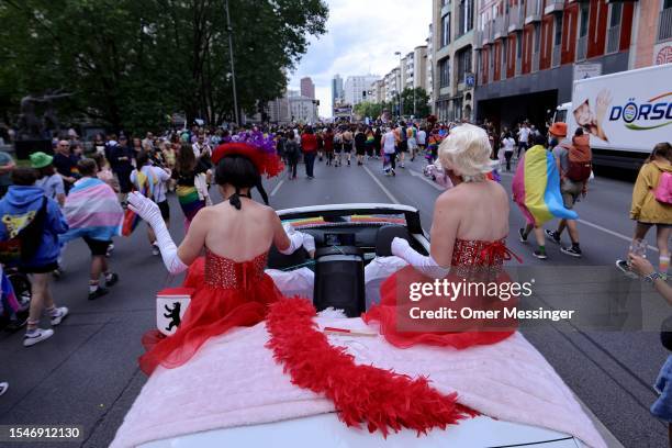 Two drag queens in red dresses atop a convertible during the annual Christopher Street Day parade on July 22, 2023 in Berlin, Germany. CSD Berlin is...