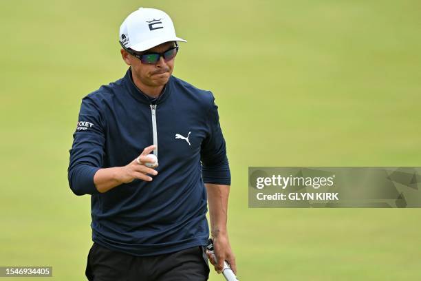 Golfer Rickie Fowler reacts after holing his putt on the 18th green on day three of the 151st British Open Golf Championship at Royal Liverpool Golf...