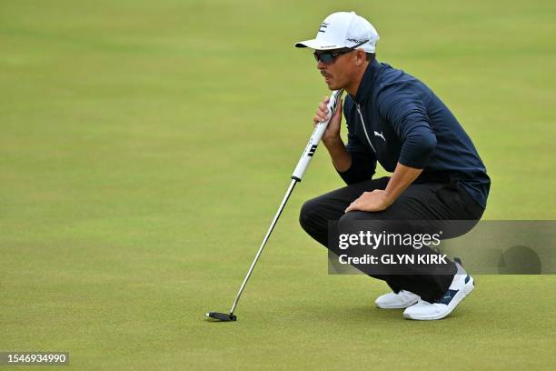 Golfer Rickie Fowler lines up a putt on the 18th green on day three of the 151st British Open Golf Championship at Royal Liverpool Golf Course in...