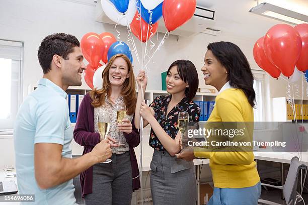 group of co-workers celebrating in office - balloon glasses stock pictures, royalty-free photos & images