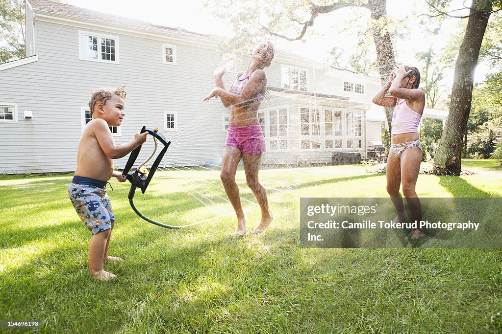 Three children playing in backyard