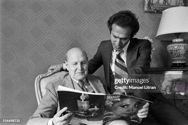 Paris, 8 November 1977 Olivier Dassault, grand-son of Marcel Dassault, poses with his grandfather, who reads Paris Match.