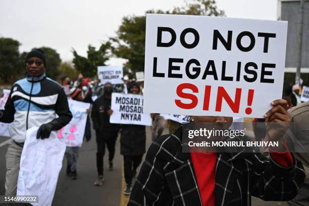 Demonstrators from the Coalition of Botswana Christian Churches chants slogans against homosexuality and hold placards while marching toward the...