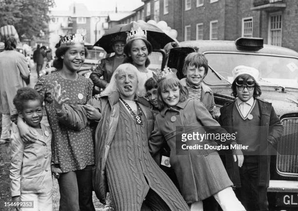 English dj and television presenter Jimmy Savile joins a group of under-privileged and disabled children on a day out to Southend, organized by...