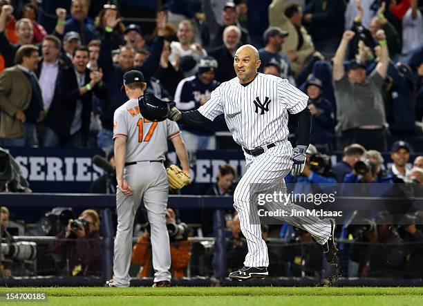 Raul Ibanez of the New York Yankees celebrates his game winning home run in the 12th inning against Brian Matusz of the Baltimore Orioles during Game...