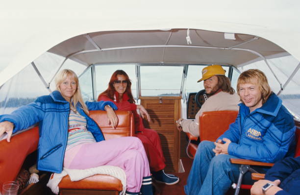 The ABBA posing on a boat with Bjorn Ulvaeus and Agnetha Faltskog his wife , Anni-Frid Lyngstad and her husband Benny Andersson at the helm.