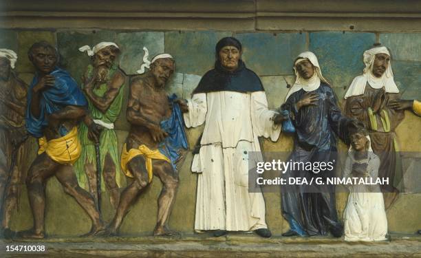 Clothe the naked and provide for widows and orphans, scene from the Seven Works of Mercy by Santi Buglioni , glazed terracotta frieze, Ceppo...