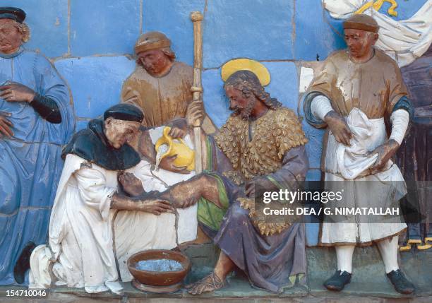 Give shelter to the pilgrims, scene from the Seven Works of Mercy by Santi Buglioni , glazed terracotta frieze, Ceppo Hospital, Pistoia, Tuscany....