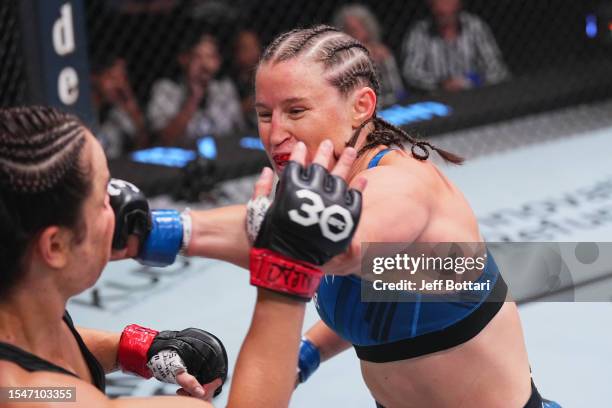 Chelsea Chandler punches Norma Dumont of Brazil in their featherweight fight during the UFC Fight Night at UFC APEX on July 15, 2023 in Las Vegas,...