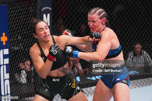 Norma Dumont of Brazil and Chelsea Chandler exchange strikes in their featherweight fight during the UFC Fight Night at UFC APEX on July 15, 2023 in...