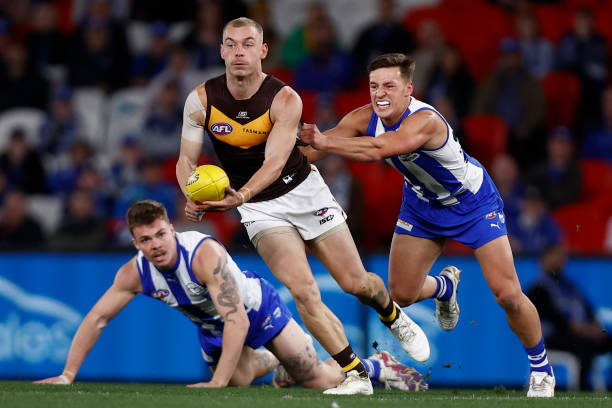 James Worpel of the Hawks handballs during the round 18 AFL match between North Melbourne Kangaroos and Hawthorn Hawks at Marvel Stadium, on July 16...