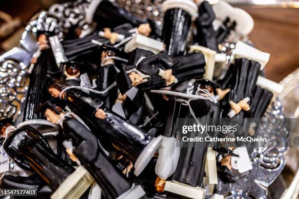 bowl of plastic figurines of graduates dressed in cap & gown at flea market - us federal trade commission stock pictures, royalty-free photos & images