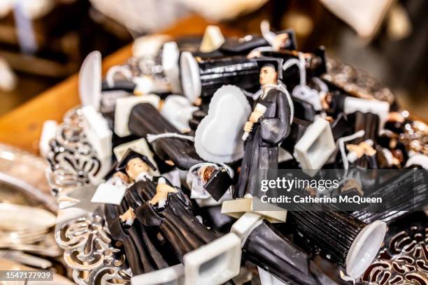 bowl of plastic figurines of graduates dressed in cap & gown at flea market - us federal trade commission stock pictures, royalty-free photos & images