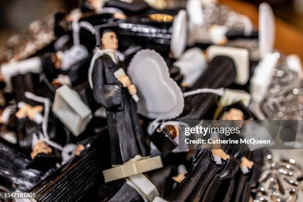 bowl of plastic figurines of graduates dressed in cap & gown at flea market - us federal trade commission stock pictures, royalty-free photos & images