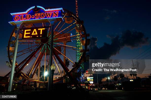 The sun sets behind a ferris wheel at Old Town in Kissimmee, Florida. The Latino vote could be decisive in swing states such as Florida. The majority...