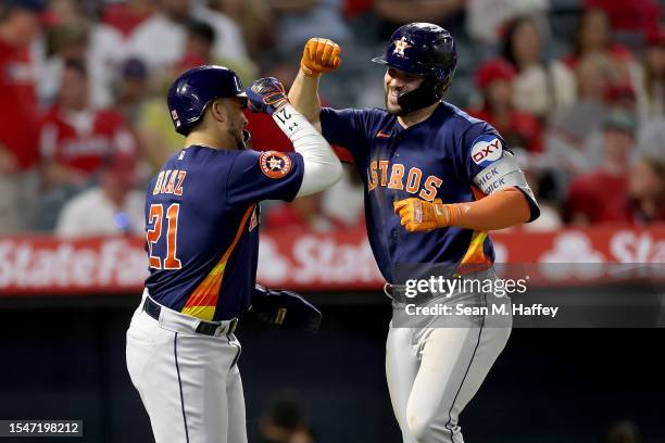 Yainer Diaz congratulates Chas McCormick of the Houston Astros after his solo homerun during the eighth inning of a game against the Los Angeles...